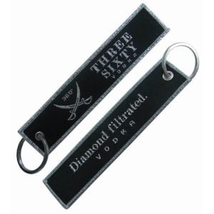 China Commemorative Custom Woven Keychain Full embroidery Shrink Proof wholesale