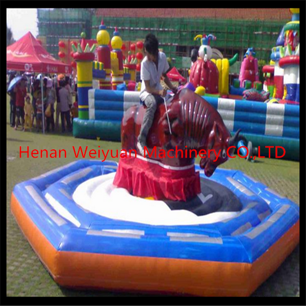 Giant Mechanical Rodeo Bull With Inflatable Mattress Interactive Game In Amusement Park